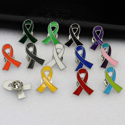 Multiple colored ribbon pins are arranged together, with one pin showing its back.