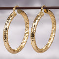 Gold Tone Large Faceted Hammered Texture Hoop Earrings view 1