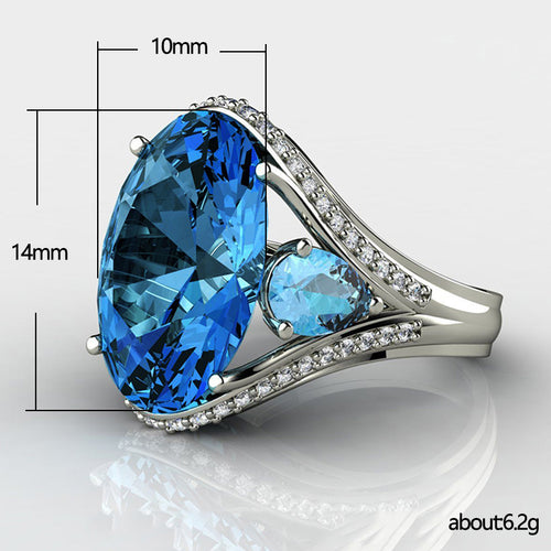 Styled view showing a large blue pear-shaped center with clear stone shoulders