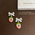 White Bow Strawberry Enamel Drop Earrings Gold Seed Accents view 3
