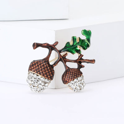 Double Acorn brooch styles arranged on a light display