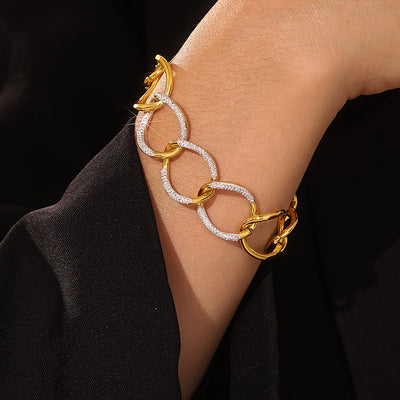 Gold interlocking link bracelet with rhinestone ovals on wrist