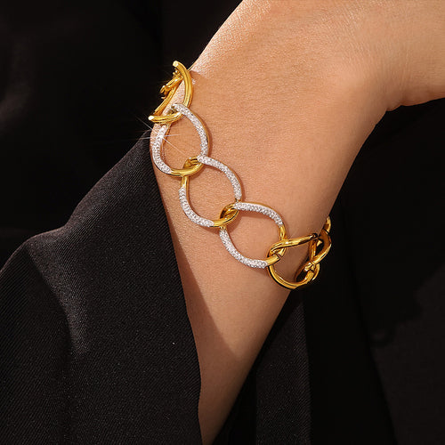 Gold interlocking link bracelet with rhinestone ovals on wrist