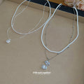 Layered White Bead and Silver Tone Pendant Necklaces view 3