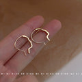 Gold Abstract Face Profile Open Hoop Earrings Minimal Outline Pair view 1