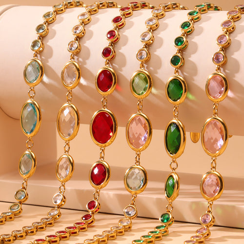 Close-up rows of multicolor gold bezel oval glass bracelets