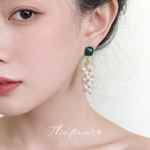 Green stud pearl cluster earring worn on ear