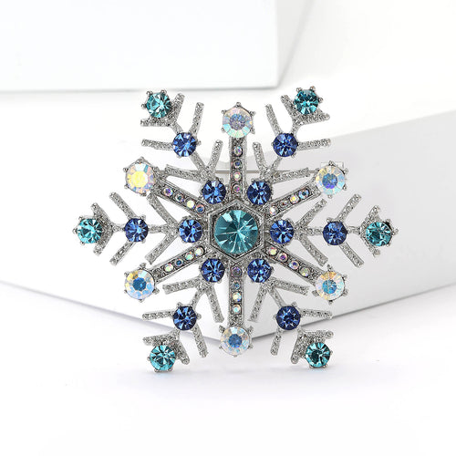 geometric snowflake brooch displayed on a product backdrop