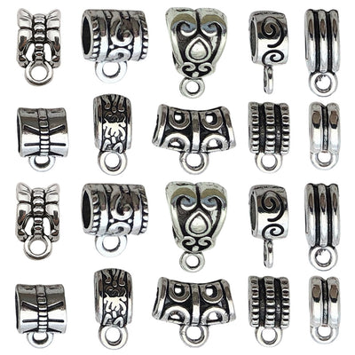 Antique silver assorted shape jewelry findings arranged on a light background