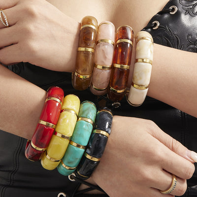 On-wrist view of compact marbled resin bracelets in main image 1.