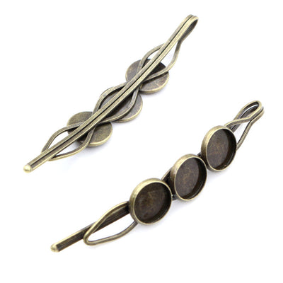 Leaf Shaped Triple Cabochon Hair Clip Base in Antique Bronze shown in a grouped front view