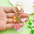 Flower Charm Keychains Featuring Pink Butterfly Across 10 Pictured Variations view 4