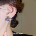 Gold Tone Square Stud Earrings with Purple Crystal Centers view 3