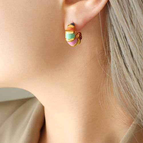 Model wearing multicolor enamel stripe C hoop earring
