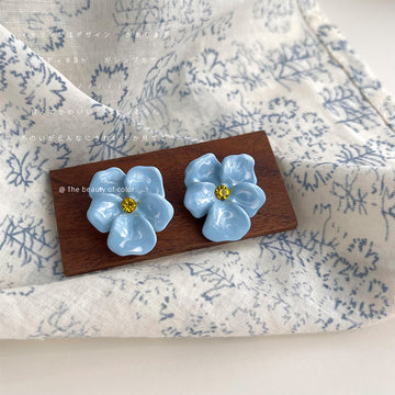 Pale Blue Five Petal Flower And Yellow Center Stud Earrings