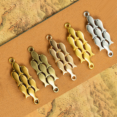 Curved school of fish connector components displayed in multiple metal finishes