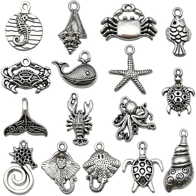 Antique silver turtle and starfish charms arranged on a light background