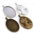 Oval Cabochon Pendant Trays with Floral Relief Backs in Two Finishes view 1