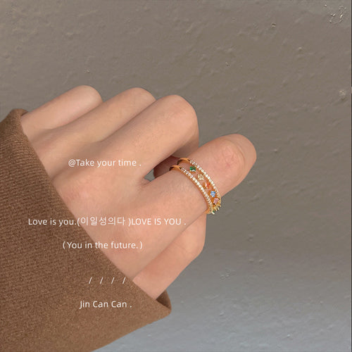 Gold-tone multicolor-baguette fringe adjustable-open ring shown in a styled view.