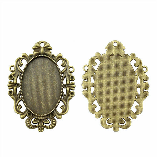 Classic Scroll Oval Cabochon Pendant Trays in Two Finishes shown in image 2 with a sculpted symmetrical border