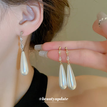 White Teardrop Dangle Earrings In Gold And Silver With Decorative Details