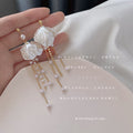Gold Tone Translucent White Flower Multi Chain Pearl Tassel Earrings view 1