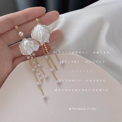 Gold-tone translucent-white-flower pearl-chain tassel earrings in the first product display.