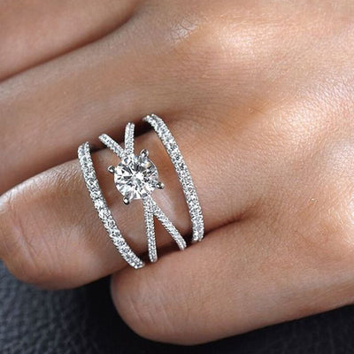 Close view of silver tone layered open band ring with clear center stone