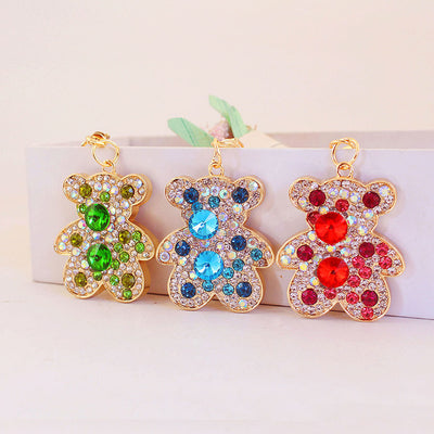 Three rhinestone teddy bear pieces in green, blue, and red displayed side by side.