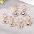 Gold Tone Crystal Blue Evil Eye Huggie Earrings in Three Shapes view 1