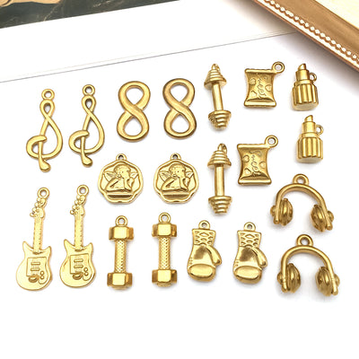 Gold-tone guitar charms arranged on a light background