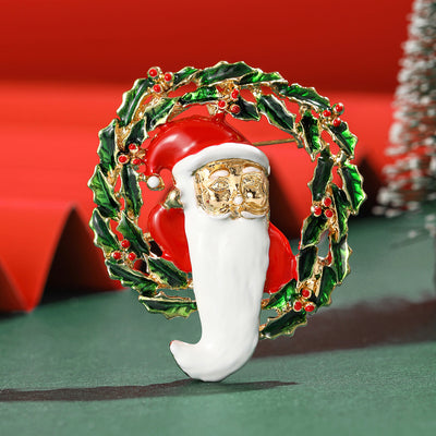 Enamel Santa Wreath Brooch shown against a white display background