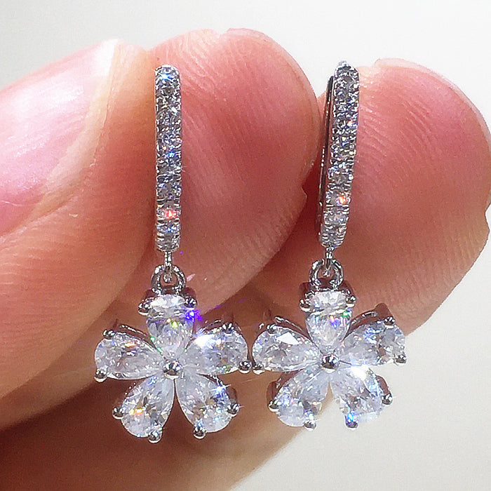 Silver Flower Drop Hoop Earrings In A Polished Decorative Design