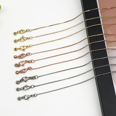 Black assorted shape charms arranged on a light background