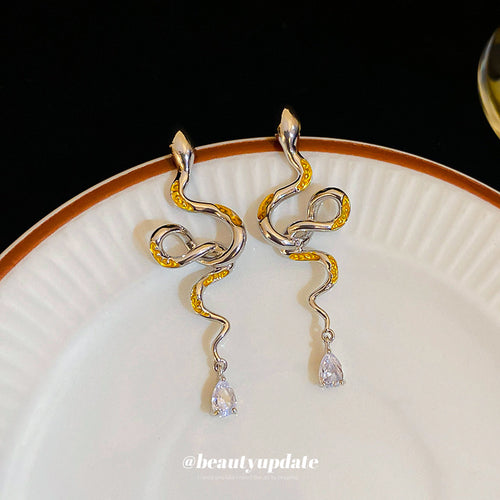 mixed metal snake drop stud earrings displayed from a second angle