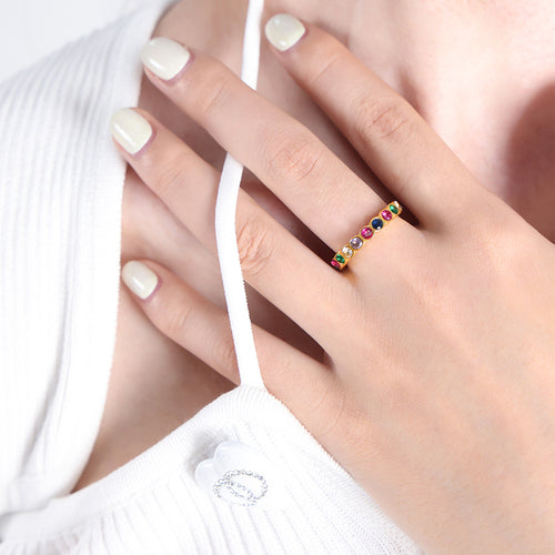 Gold multicolor round zircon eternity band worn on ring finger
