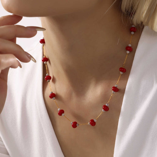 Model wears red natural stone disk bead gold chain necklace