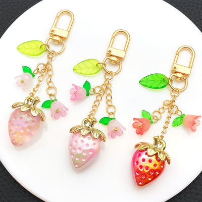 Overview showing the available color and design variations of the red pink and purple strawberry flower metal clasp keyc