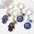 Gold and Silver Tone Round and Hamsa Evil Eye Split Ring Keychains view 1