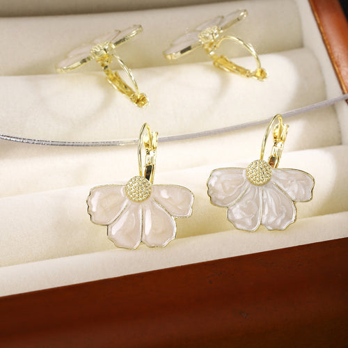 White enamel petal flower leverback earrings in cream jewelry box slots