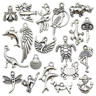 Metallic dragonfly and crab charms arranged on a light background