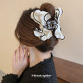 White Satin Bow Hair Claw With Black Piping And Pearl Like Center view 1