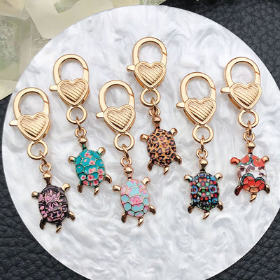 Front product photo of colorful printed turtle lobster clasp charm showing the pictured design arrangement