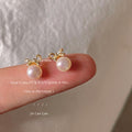 Gold Tone Bow And White Pearlescent Drop Stud Earrings view 1