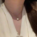 Gold Tone Pearl Drop Earrings with Textured Oval Frames view 4