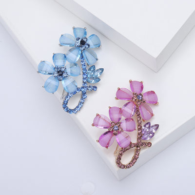 Blue and purple dual flower crystal brooches side by side