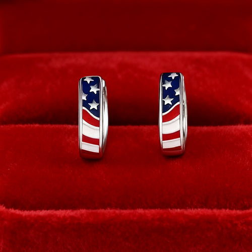 Pair of flag enamel hoops displayed on red velvet