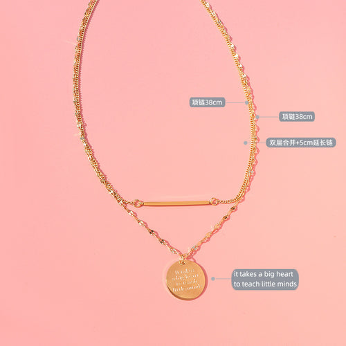Gold bar disc necklace flat on pink with length and quote labels