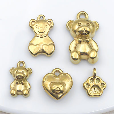 Gold-tone bear charms arranged on a light background
