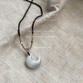 Dark Braided Cord Necklace With White Pearlescent Crescent Pendant view 4